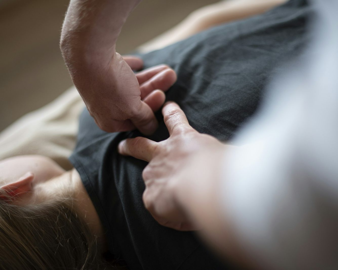 Osteopath working on a patient's upper back