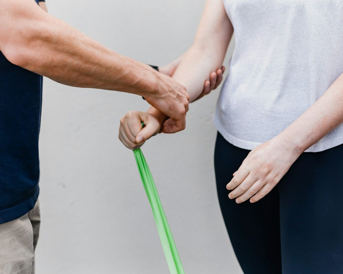 Physiotherapist guiding a resistance-band exercise